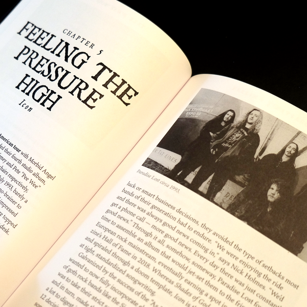 Open book with text and a black and white photo of a band on a dark background