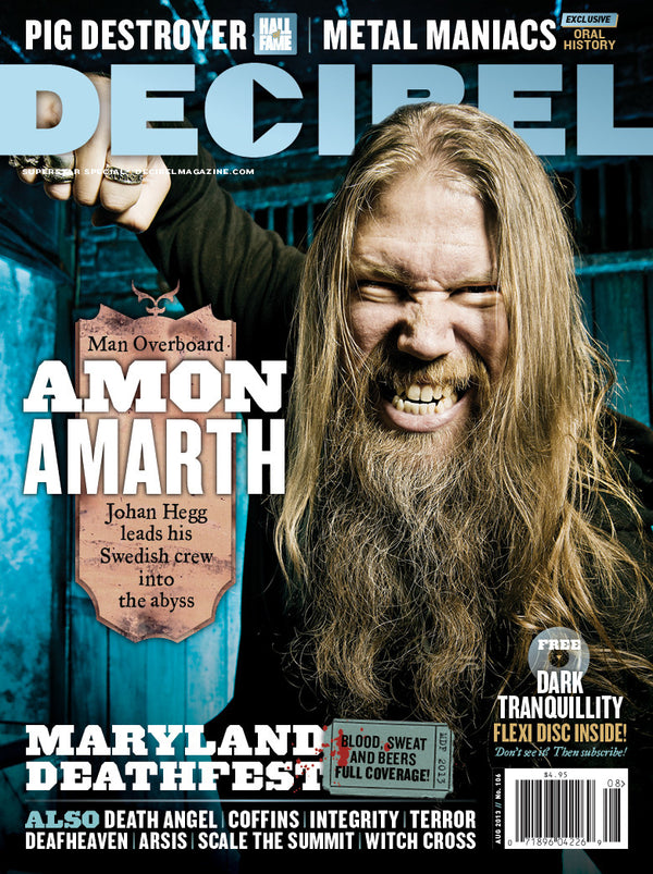 Cover of Decibel Magazine featuring Amon Amarth band member Johan Hegg with long hair, smiling, and holding a microphone.